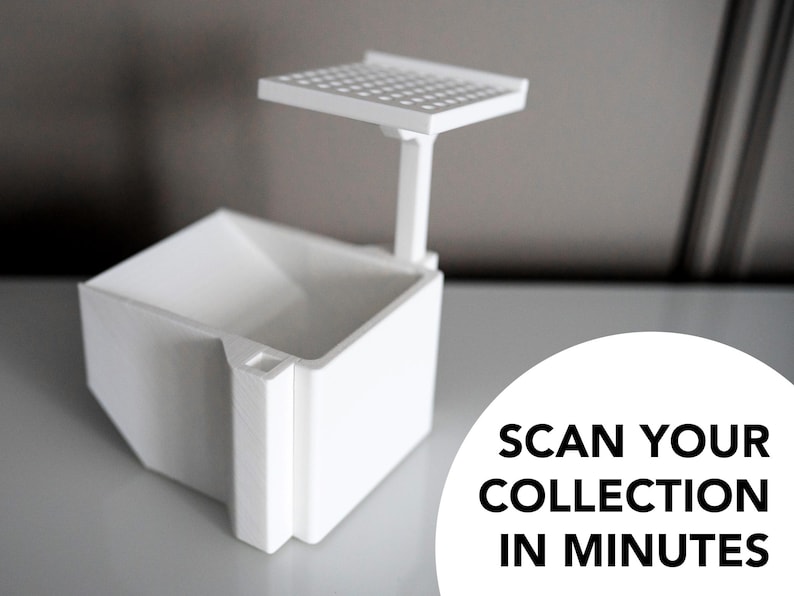 3D-printed white trading card scanner and dispenser tray with a built-in phone stand. Designed for TCG, MTG, Pokémon, and Lorcana, allowing easy card scanning with apps like Manabox, TCGPlayer, and Delver Lens. Perfect for collectors and sellers.