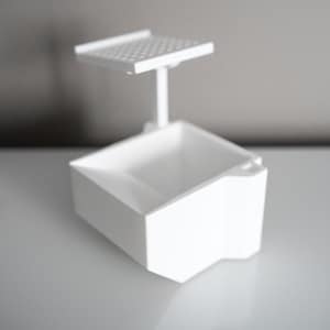 3D-printed white trading card scanner and dispenser tray with a built-in phone stand. Designed for TCG, MTG, Pokémon, and Lorcana, allowing easy card scanning with apps like Manabox, TCGPlayer, and Delver Lens. Perfect for collectors and sellers.