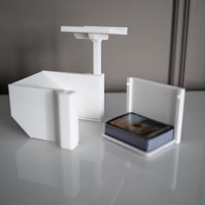 3D-printed white trading card scanner and dispenser tray with a built-in phone stand. Designed for TCG, MTG, Pokémon, and Lorcana, allowing easy card scanning with apps like Manabox, TCGPlayer, and Delver Lens. Perfect for collectors and sellers.