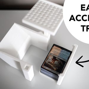 3D-printed white trading card scanner and dispenser tray with a built-in phone stand. Designed for TCG, MTG, Pokémon, and Lorcana, allowing easy card scanning with apps like Manabox, TCGPlayer, and Delver Lens. Perfect for collectors and sellers.