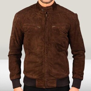 May include: A brown suede bomber jacket with a zipper closure and ribbed knit cuffs and waistband.