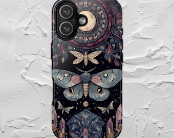 May include: A phone case featuring a detailed illustration of a large moth with blue, pink, and black wings. The design includes a crescent moon, stars, and geometric shapes in shades of purple, blue, and gold.
