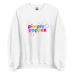 May include: White sweatshirt with a rainbow colored graphic that says "pimple popper" with cartoon bubbles around the text.
