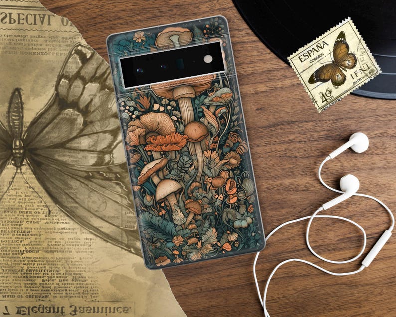 Peut inclure: Une coque de t&eacute;l&eacute;phone avec un fond bleu fonc&eacute; et une illustration color&eacute;e de champignons et de fleurs. La coque a une d&eacute;coupe pour l'appareil photo du t&eacute;l&eacute;phone.