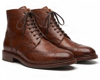 May include: A pair of brown leather lace-up boots featuring a wingtip design with decorative brogue perforations along the seams, a rounded toe, a stacked heel, and dark brown laces tied at the top of the ankle-high shaft.