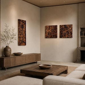 May include: A contemporary living room in neutral shades. It features a wooden coffee table, a long wooden cabinet, and a beige sofa. The walls display textured brown artwork. A large vase with branches sits on the cabinet, enhancing the room's aesthetic.