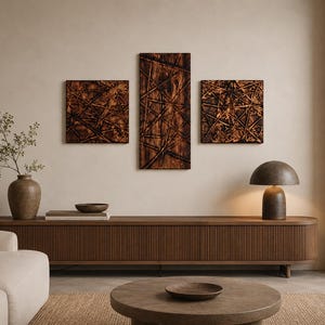 May include: A living room scene with a wooden console table, a round coffee table, and a cream sofa. Three abstract wooden wall art pieces hang above the console. A brown lamp and a vase with greenery complete the decor.