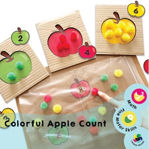 Op de afbeelding: Kleurrijke appeltel-activiteit voor kinderen. De activiteit bevat 5 appelkaarten met de nummers 2, 3, 4, 5 en 6. Elke appelkaart heeft een overeenkomend aantal pompoenen om te matchen. De activiteit bevat ook een doorzichtige plastic zak met pompoenen in rood, groen en geel.