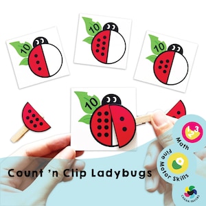 Puede incluir: Conjunto de actividades 'Count 'n Clip Ladybugs' con mariquitas rojas y negras con puntos blancos y hojas verdes. Las mariquitas están divididas en dos y el niño puede sujetar las mitades juntas. El conjunto incluye una pinza de madera. La actividad está etiquetada como 'Count 'n Clip Ladybugs'.