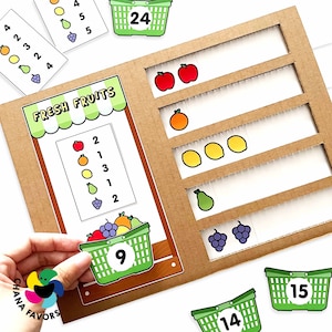 May include: A brown cardboard game board with a green and white fruit stand on the left side. The fruit stand has a sign that says "FRESH FRUITS". There are five shelves on the right side of the board with different fruits on each shelf. There are also several green baskets with numbers on them. The numbers on the baskets are 9, 14, 15, and 24.