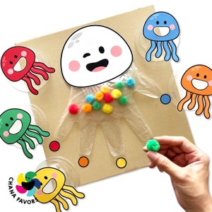 May include: A white plastic hand with a smiling face, holding colourful pom-poms.  There are five colourful jellyfish surrounding the hand, each with a different expression.  The text "CHANA FAVORS" is visible in the bottom left corner.