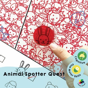 May include: A white sheet of paper with a red and black illustration of various animals. The paper has the text "Animal Spotter Quest" printed on it. A clear plastic circle with a red rabbit illustration is being held over the paper by a hand.
