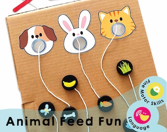 May include: A cardboard game board with three animal faces: a dog, a rabbit, and a cat. Each animal has a hole in its face. There are five different colored circles with strings attached to them. The strings are connected to the holes in the animal faces. The game board has the words "Animal Feed Fun" printed on it. There are also four circular labels with text: "Fine Motor Skills", "Language", "Chana Favors", and "Build".