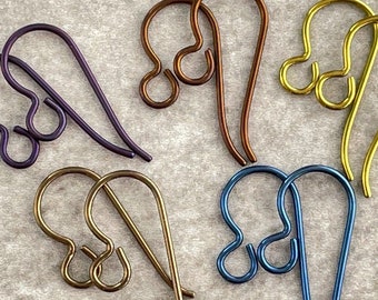May include: Six pairs of earring hooks in different colors: purple, brown, gold, and blue. The hooks are made of metal and have a simple, elegant design.