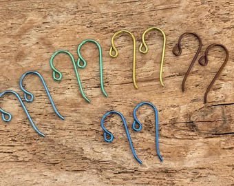 May include: A set of ten earring hooks in various colors, including blue, green, yellow, and brown. The hooks are made of metal and are designed for use with jewelry making.
