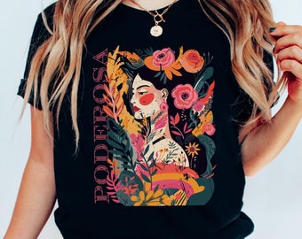 May include: Black t-shirt with a colorful illustration of a woman with flowers and the word "PODEROSA" in pink lettering.