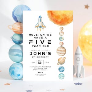 May include: A space-themed birthday invitation with the text "Houston We Have a Five Year Old." The invitation features a rocket ship, planets, and a sun illustration. The invitation is for John's 5th birthday, July 12th at 2 PM.