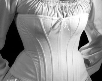 May include: A white cotton corset with a gathered neckline and a lace-up front. The corset has a fitted bodice and a full skirt.