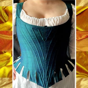 May include: A teal blue corset with a pointed front and a scalloped bottom edge. The corset is made of a silky fabric with a subtle sheen.