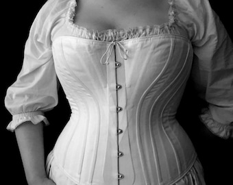 May include: A white corset with a lace trim and a row of silver buttons down the front.