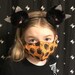 Chloe Steele reviewed Halloween Black Cats mask unisex girls boys, kid adult 2 layer cotton shaped cute spooky goth print fabric, pocket w/filter, nose wire