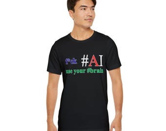 May include: Black t-shirt with the text "f*ck #AI use your #brain" in a colorful font. The shirt is a crew neck style and is being worn.