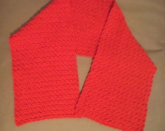 May include: A bright red crocheted scarf with a textured pattern.