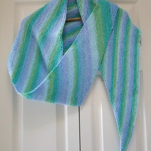 May include: A blue and green striped knitted scarf with a long, pointed end.