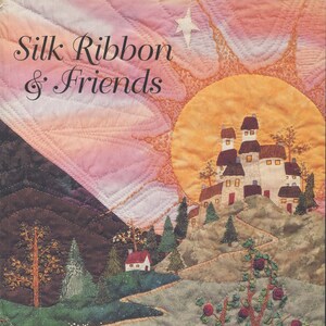 May include: A book titled "Silk Ribbon & Friends" by Piecemakers. The cover features a colorful quilted landscape with a white castle, a red-roofed house, and a sun setting behind a mountain range.