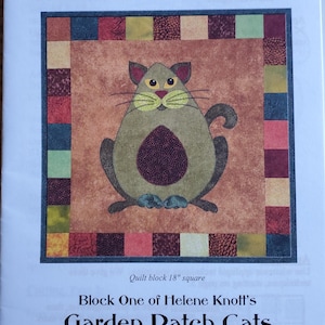 May include: A quilt block pattern featuring a whimsical cat design shaped like an avocado, with the word "Avocato" above. The quilt block is 18 inches square and includes a recipe for chicken and avocado salad.