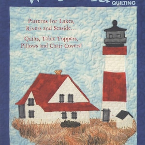 May include: Waterside Quilting book cover featuring a red-roofed white house and a red and white lighthouse on a blue background with the text "Patterns for Lakes, Rivers and Seaside... Quilts, Table Toppers, Pillows and Chair Covers!" and "by Cheryl Haynes" and "No. 5271".