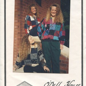 May include: Three women wearing colorful patchwork shirts pose in front of a brick building. The sign above them reads "Tacky Tops." The sign below them reads "O'Dell House 466 S. Odell Marshall, Mo. 65340 816-886-3663."