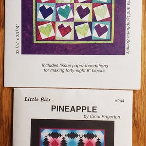 May include: Two quilt pattern covers. The top one is titled "HEARTFELT" with a heart design. The bottom one is titled "PINEAPPLE" with a geometric design. Both are by Cindi Edgerton.