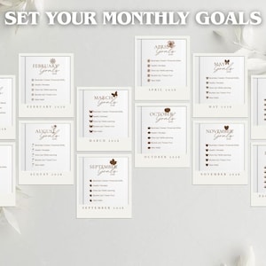 May include: A collection of twelve monthly goal-setting cards, each with a decorative border and a unique seasonal icon. The cards are arranged to display the months of the year, with the text "Set Your Monthly Goals" at the top.