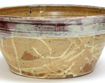 flat-bottomed beige bowl edged with red