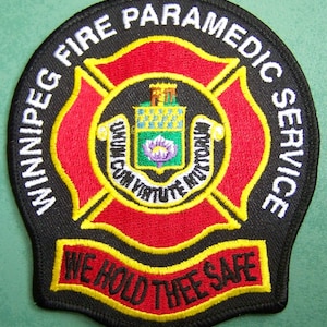 May include: Black and red embroidered patch with the words "Winnipeg Fire Paramedic Service" and "We Hold Thee Safe" in a yellow banner.