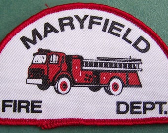 May include: A white patch with a red border, depicting a red fire truck with black details. The text "MARYFIELD FIRE DEPT." is printed in black.