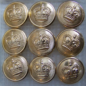 May include: Eight gold-colored buttons with a crown design. The buttons are round and have a raised design.