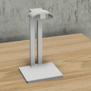 May include: White plastic headphone stand with a curved top and a square base.