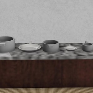 Puede incluir: Un juego de cinco utensilios de cocina grises sobre una encimera marrón. El juego incluye una olla grande, una olla mediana, una olla pequeña, un plato y un tazón pequeño.