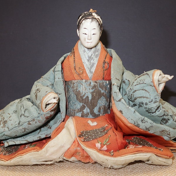 Antique Sitting Doll, Dressed in a Kimono Measures 6 x 9 inches wide