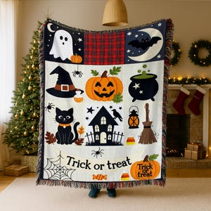 May include: A woven throw blanket featuring a Halloween theme with a ghost, a black cat, a jack-o'-lantern, a witch hat, a cauldron, a haunted house, and a broom. The text "Trick or treat" is printed at the bottom with spiderweb and candy motifs.