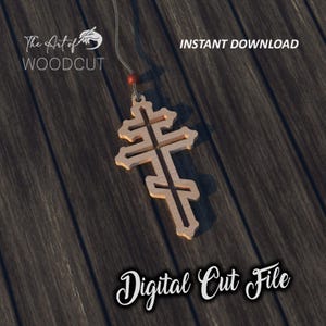 Puede incluir: Un colgante de madera en forma de cruz con detalles intrincados. El colgante está colgado de una cuerda con una cuenta roja. El fondo es una superficie de madera oscura. El texto "Digital Cut File" está escrito debajo del colgante.