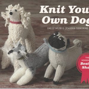 May include: A book titled Knit Your Own Dog by Sally Muir and Joanna Osborne featuring three knitted dog figures: a white poodle, a grey and white terrier, and a fawn pug with a black face. A red ribbon graphic reads The Winners of Best in Show.