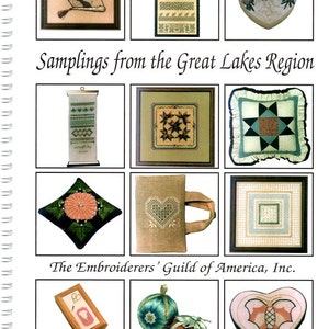 May include: A collection of twelve embroidered items arranged in a grid, including framed samplers, heart-shaped boxes, a pillow, and ornaments. The text reads Samplings from the Great Lakes Region and The Embroiderers' Guild of America, Inc.