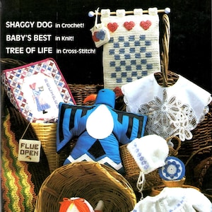 May include: Cover of "Annie's Pattern Club" newsletter from Dec-Jan 1987, featuring various handmade crafts. Includes a crochet "Shaggy Dog", knitted baby items, and a cross-stitch "Tree of Life". The cover also displays a sign that says "Flue Open".