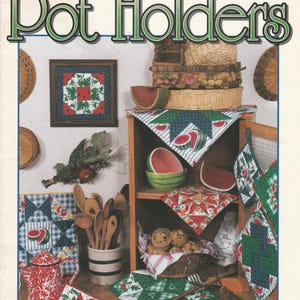 May include: A book cover titled "Pot Holders" with a green and white color scheme. The cover features various pot holders, watermelon-themed decor, and the text "48 Quilt Block Favorites You'll Love to Stitch!"