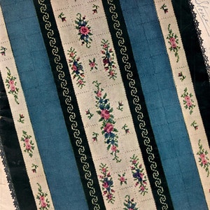 May include: Vintage book cover titled "WEAVE-IT AFGHANS" with a blue, white, and black floral design. The cover features a central blue stripe flanked by white stripes with floral embroidery. The text "BOOK NO 4 BY HERO PRICE 50¢" is visible.