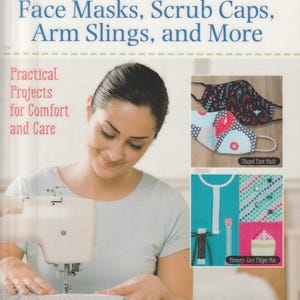 May include: A book titled SEWING Face Masks, Scrub Caps, Arm Slings, and More: Practical Projects for Comfort and Care by Angie Herbertson. The cover features a person using a sewing machine and images of a shaped face mask and a memory-care fidget mat.