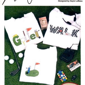 May include: White t-shirts with cross-stitch designs featuring golf and walking themes. One shirt says "Golfer" with golf-related graphics. Another says "Walk" with a sneaker graphic. The third shirt has a golf course design.